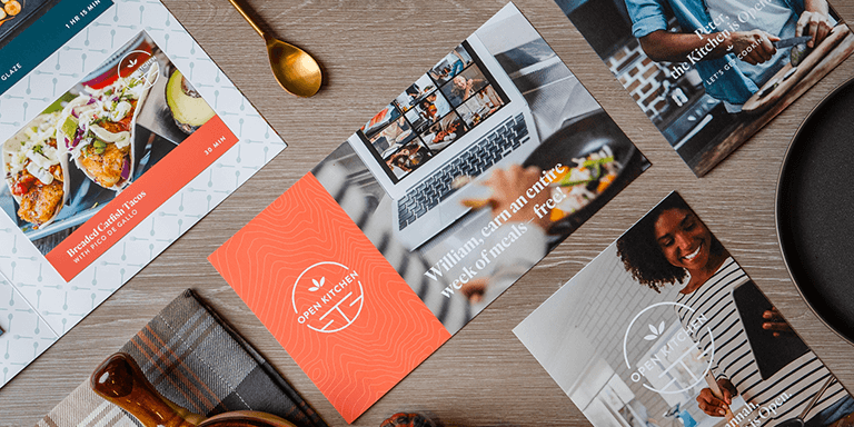 Various restaurant marketing brochures on a table