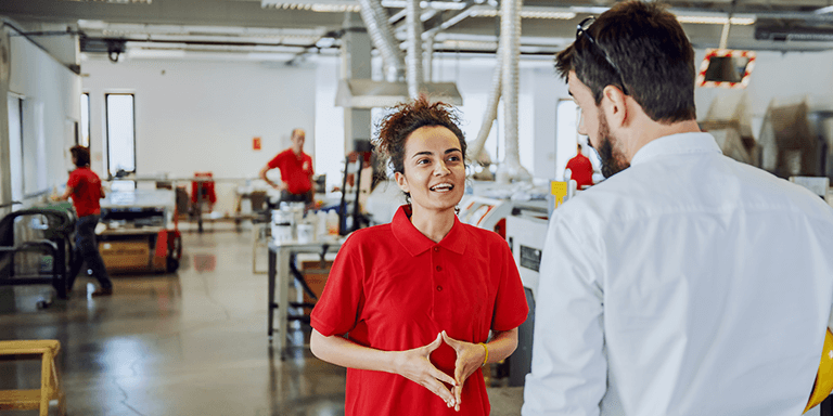 two people talking on a shop floor