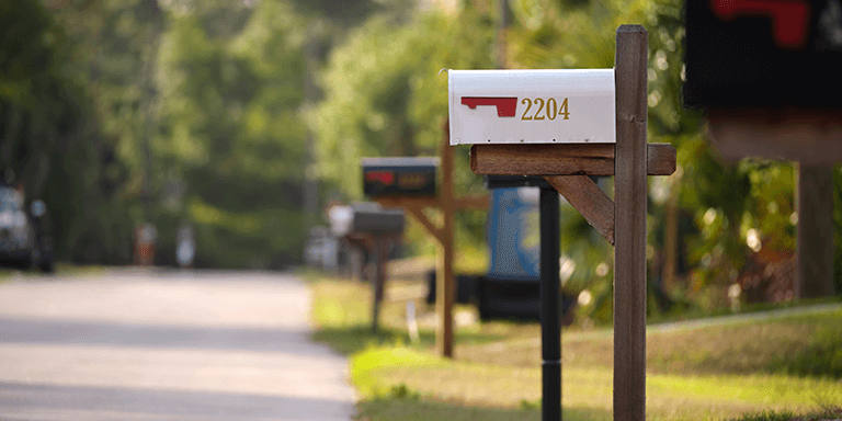 A line of mailboxes on a neighborhood street