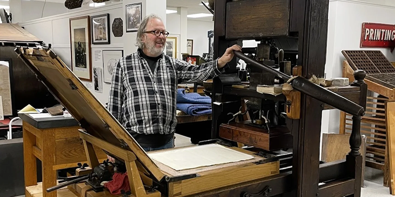 Operator standing near a printing press