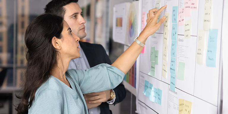 Co-workers reviewing brand ideas on a board