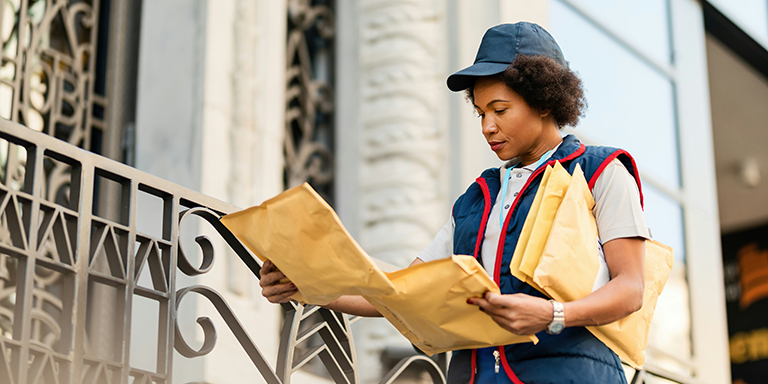 Postal worker delivering a package