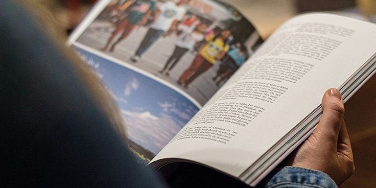 Person reading from a printed book